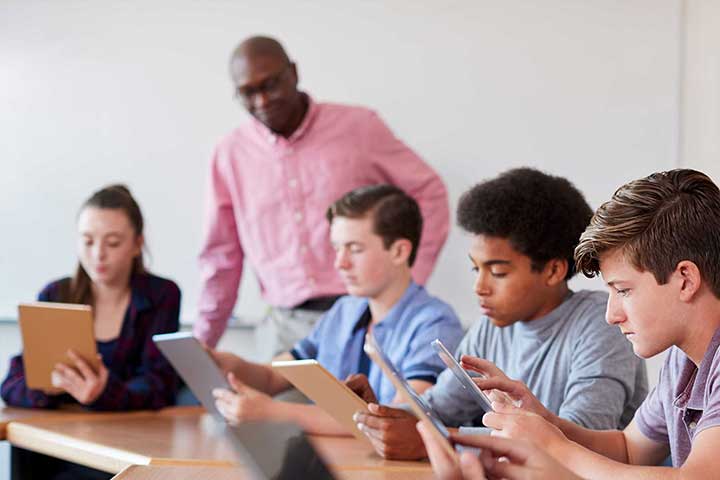 Teacher Observing Students Working in Class