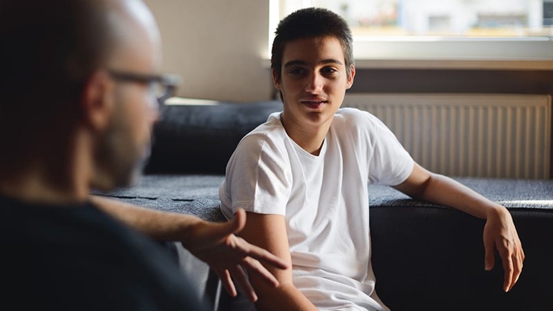 Parent and teenager having a positive supportive conversation about school and future